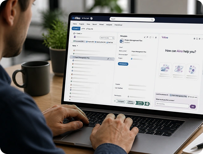 Person typing on a laptop displaying a multi-pane project management dashboard with tasks and metadata